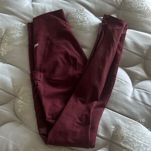 Maroon Fabletics leggings with mesh accent on sides